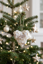 Load image into Gallery viewer, Cream button heart on a Christmas tree with warm lights and neutral festive decorations
